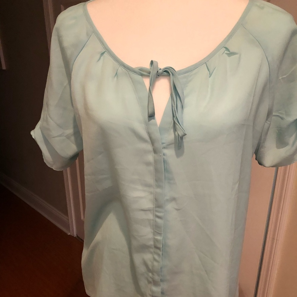 Light blue blouse with ruffle detail on sleeves